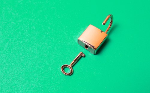 key and lock on bright green background