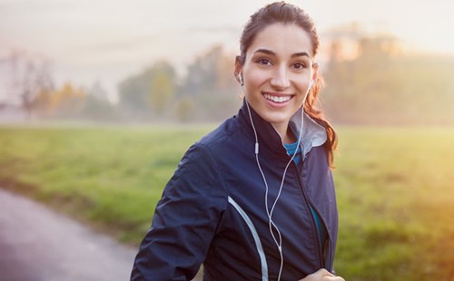 Young woman jogging wearing headphones