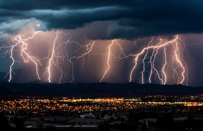 Storm clouds with lightning over a city