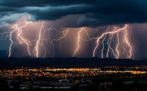 Storm clouds with lightning over a city