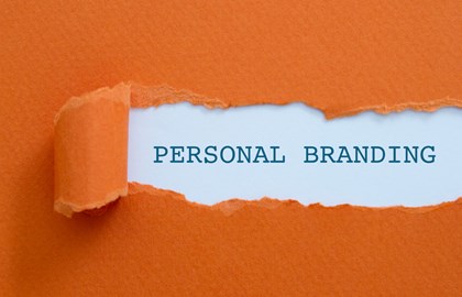 deep orange paper torn away to reveal the words "personal branding"