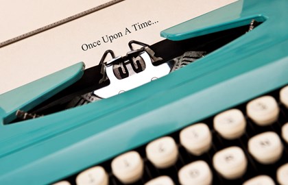 teal typewriter with paper that reads "once upon a time"