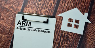 Clipboard on desk with notes about adjustable-rate mortgages